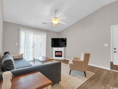 Living room featuring ceiling fan, lofted ceiling,
