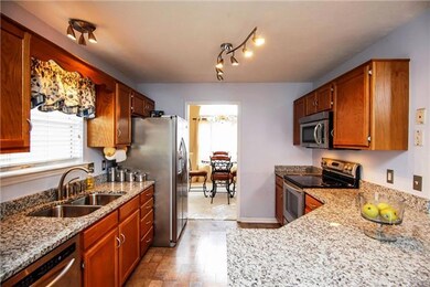 Granite counters, Stainless steel appliances, refrigerator stays, wood floors, track lighting