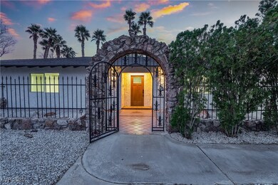 View of exterior entry featuring fence and a gate