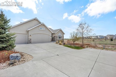 Ranch-style house with an attached three-car garage, driveway, stone siding, and stucco siding