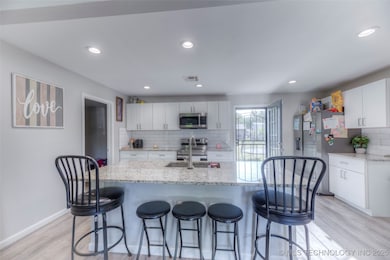 Kitchen featuring stainless steel appliances, a si