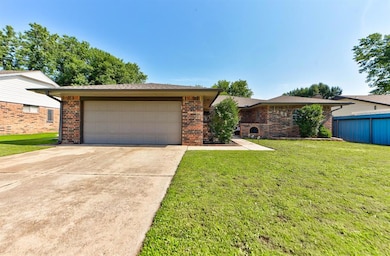 Ranch-style house featuring brick siding and driveway