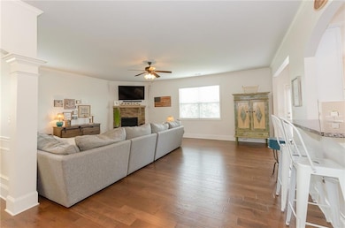 Dining area with decorative columns, beamed ceiling, arched walkways, coffered ceiling, and dark wood-type flooring