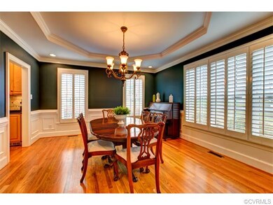 Gorgeous dining room with wood floors, wainscoting