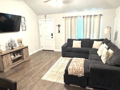 Living Area features large windows, laminate wood
