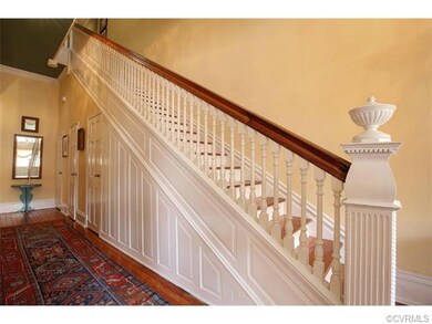 Front hallway foyer boasts a wet bar, half bath and large coat closet