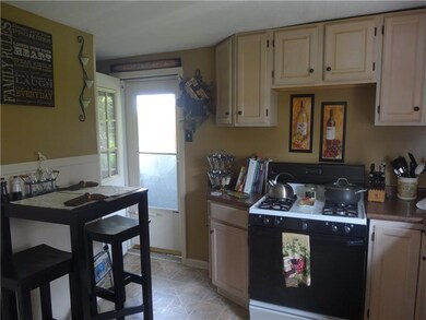 Kitchen open to covered rear porch.