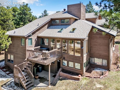 Rear view of property with a chimney, stairway, a patio area, a wooden deck, and a shingled roof