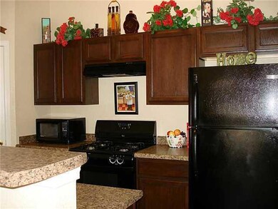 Kitchen with breakfast bar island. Frig