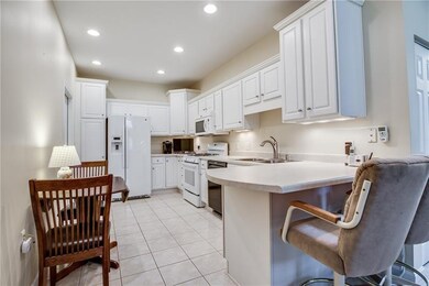 White Kitchen Cabinets with Neutral Countertops an