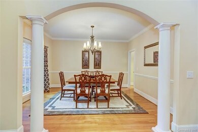 Formal dining room features, arched columned entry