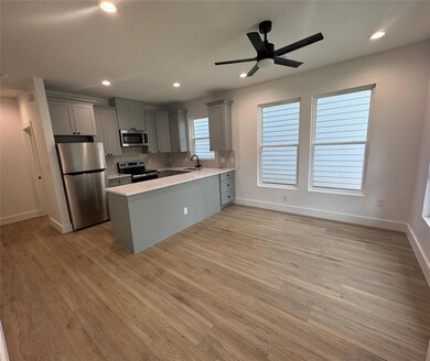 Kitchen with stainless steel appliances, light wo