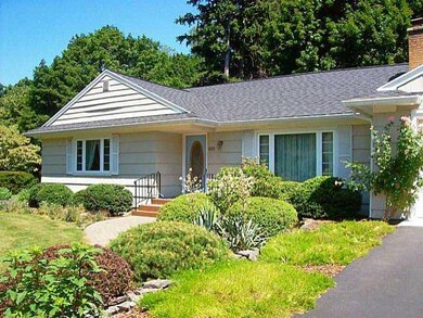 Exterior Front. Landscaping includes the paver wal