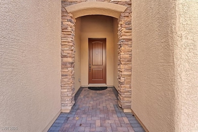 Property entrance with stucco siding and stone siding