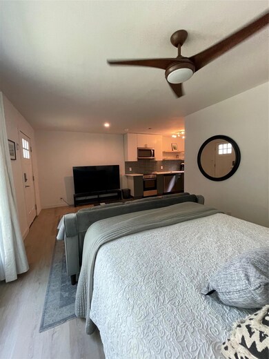 Bedroom with light wood-type flooring and ceiling