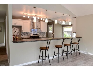 Kitchen has a lovely breakfast bar with seating fo