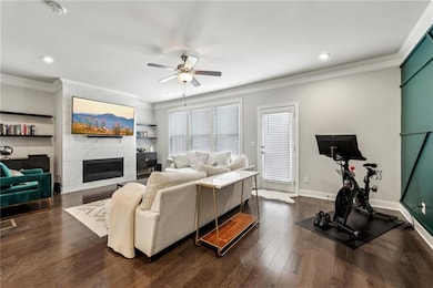 Living area featuring baseboards, dark wood finish