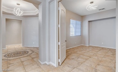 Hallway featuring a chandelier, crown molding, lig