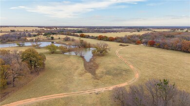 Birds eye view of property with a water view and a