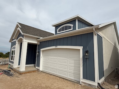 View of front of home featuring a shingled roof, board and batten siding, and driveway
