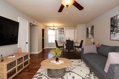 Living room featuring ceiling fan with notable cha