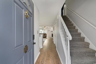 Stairway with a fireplace with raised hearth, a te