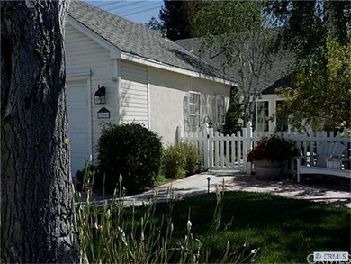 New vinyl front entry gate and fence leads to  a l