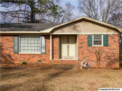 Double doors under a covered front porch wait to greet your guests. The home has been freshly painted both inside and out, and all of the doors have new hardware.