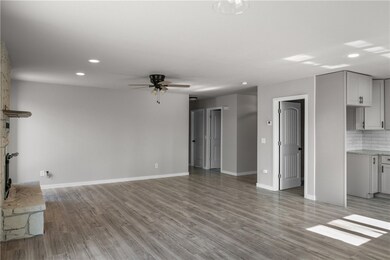 open floor plan with kitchen, pantry and cozy fireplace