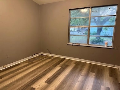Spare room with wood finished floors and baseboard