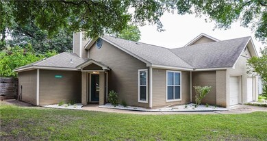 View of front of home with an attached garage, a 