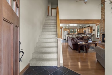 Stairway featuring baseboards, a towering ceiling,