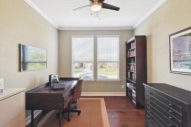 Office area featuring ceiling fan, dark hardwood /