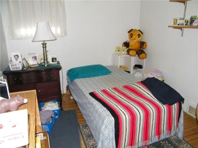 Bedroom with hardwood floors.