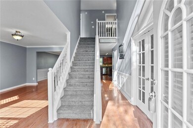 Stairs with wood finished floors and french doors