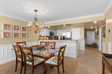 Dining area with crown molding, a wainscoted wall,