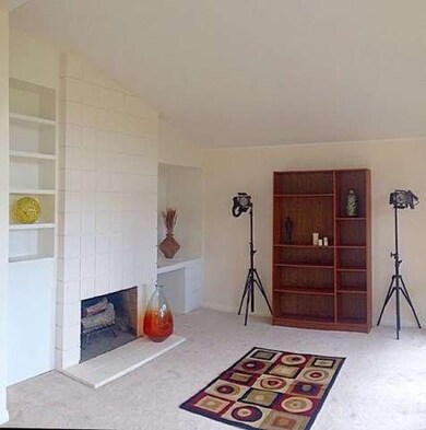 Den/family room with fireplace, opens to a private