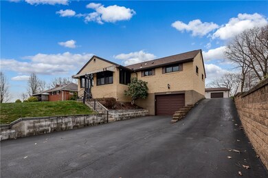 A dual driveway connects the integral garage and t