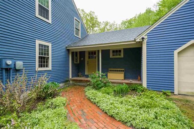 Brick walkway, perennial garden, attached 2-car garage