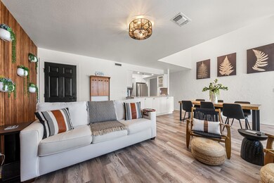 Living area with baseboards, light wood-type floo