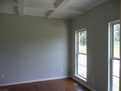 Living room with hardwoods and coffered ceilimg