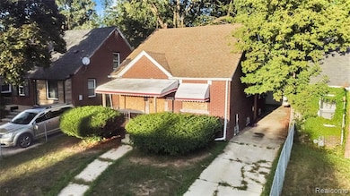 View of front facade featuring a shingled roof and brick siding