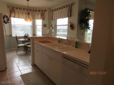 Kitchen with white appliances, a sink, white cabin