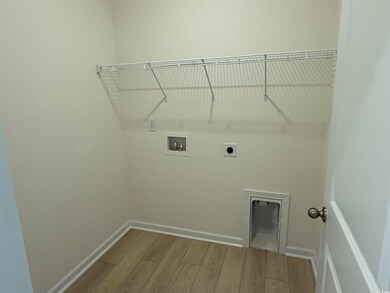 Laundry room with hookup for a washing machine, wood finished floors, electric dryer hookup, and baseboards