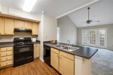 Black appliances are in the kitchen with a new gar