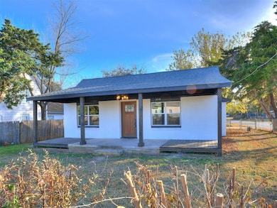 View of front of home with covered porch and brick siding