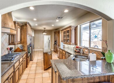 Kitchen with a kitchen island, tasteful backsplash