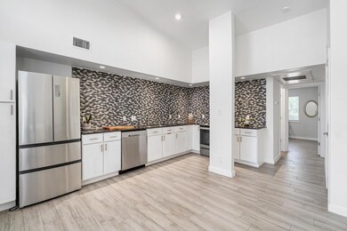 Kitchen with stainless steel appliances, dark cou