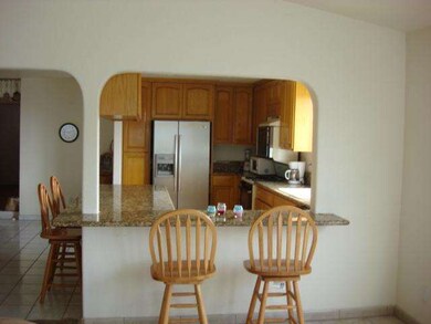 Kitchen breakfast bar on side of family room.
