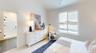 Bedroom featuring light colored carpet, lofted ceiling, baseboards, and connected bathroom